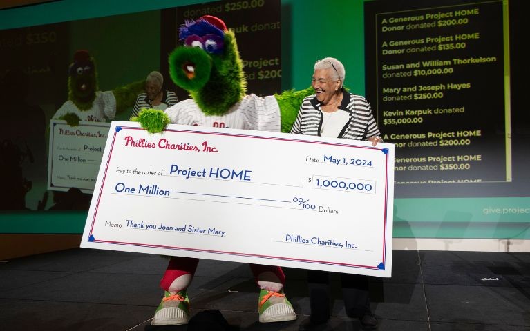 The Phillie Phanatic holds a ceremonial check for one million dollars