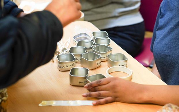 Residents label candle tins