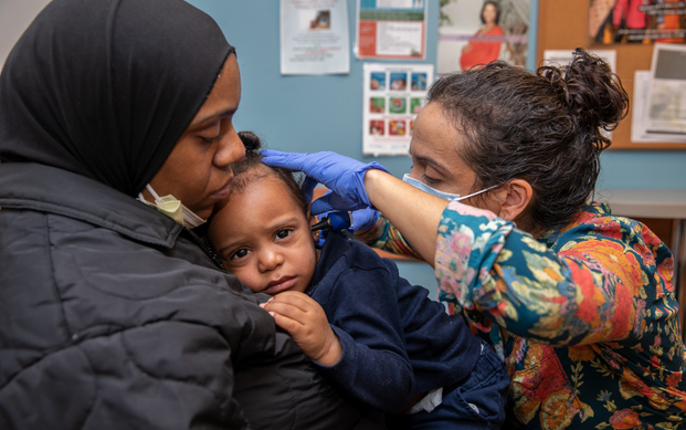 A child receives an examination at SKWC.