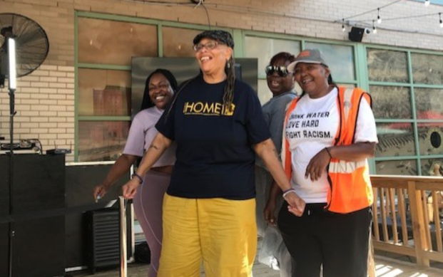 Carol, pictured in the Project HOME shirt, flashes a smile at this the 2023 staff social event.