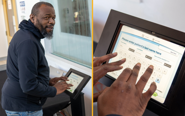 A SKWC staff member shares a smile and demonstrates how to use their new patient portal.