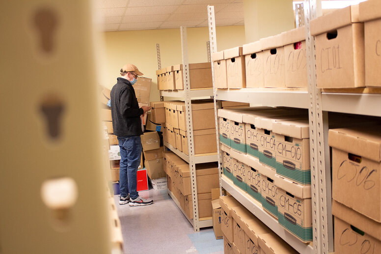 Project HOME Books employee sorts books into boxes