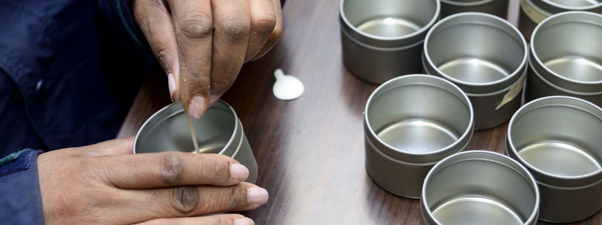 Close-up of a person making candles.