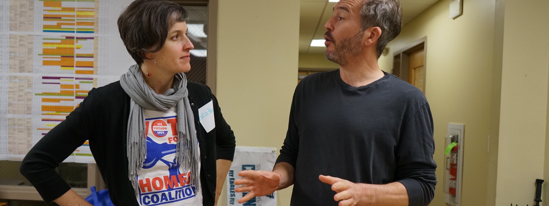 Vote for Homes Coalition members talk during a voter registration drive.