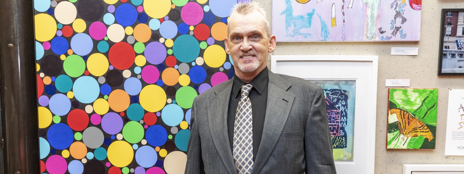 A Project HOME resident and art program participant at an art show
