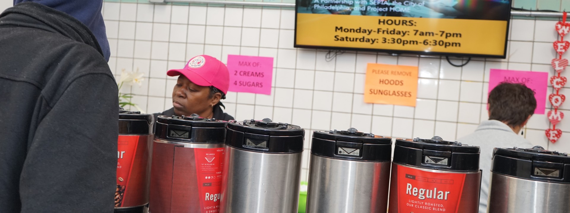 A Project HOME volunteer serves coffee at the Hub of Hope