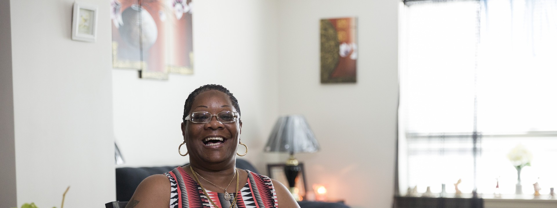 A Project HOME resident sits in their apartment
