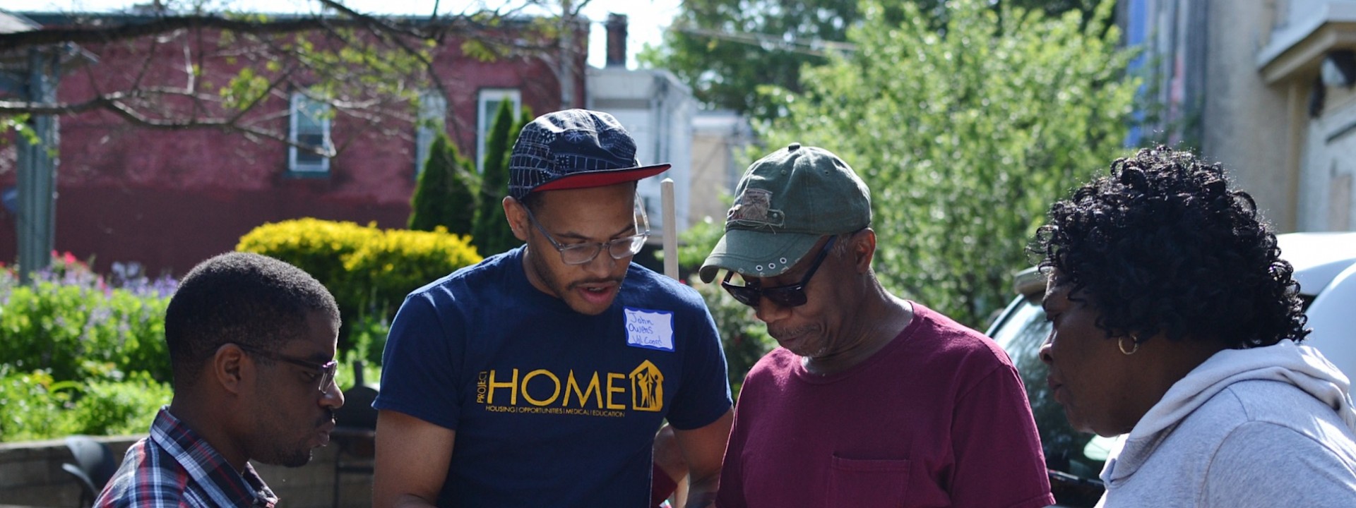 Project HOME volunteers coordinating during a neighborhood clean up day