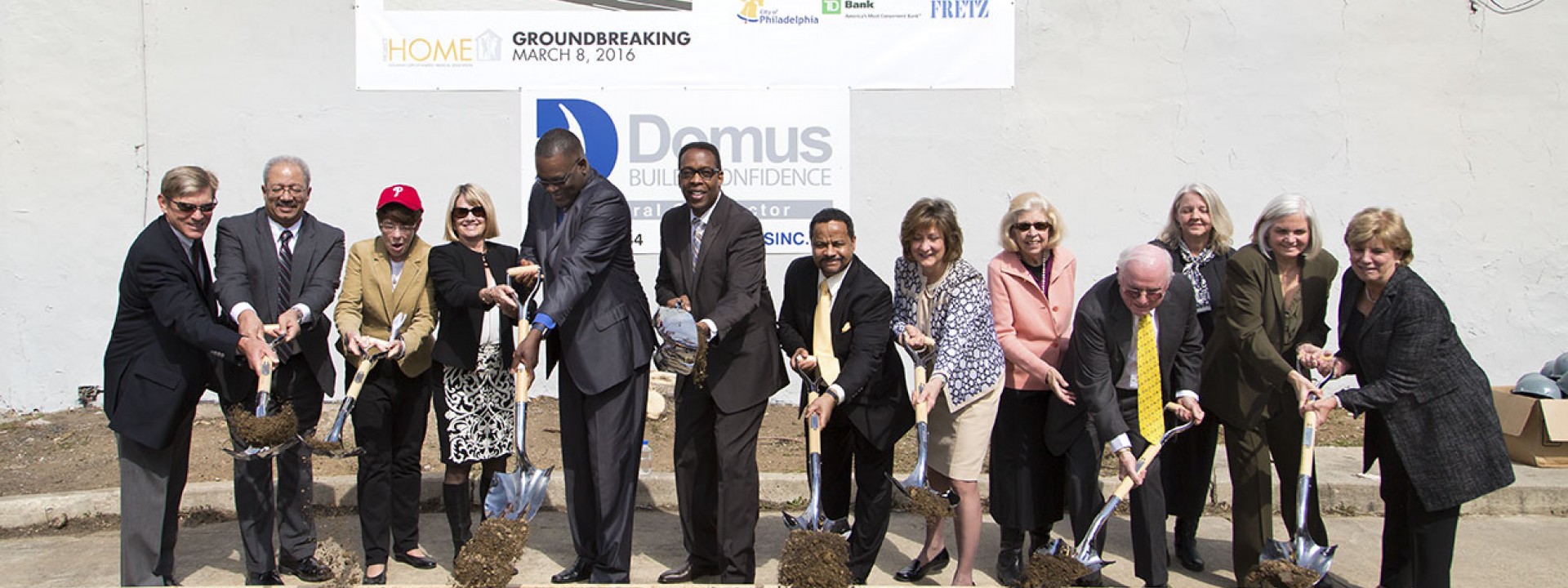 A group of people throwing shovels of dirt