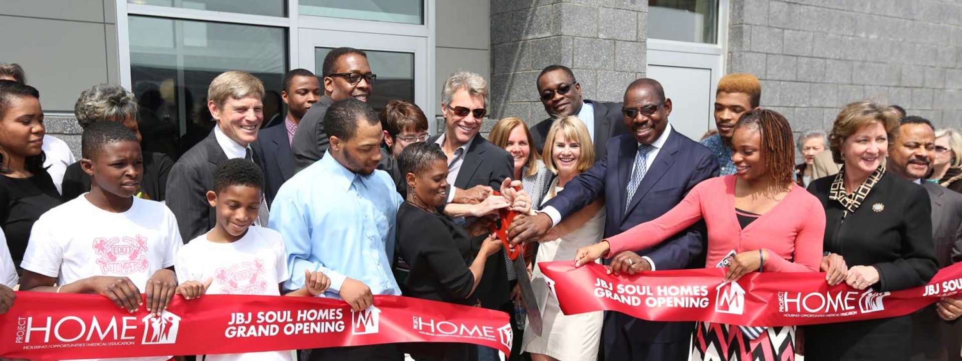 Cutting the ribbon at the grand opening celebration for Project HOME's JBJ Soul Homes, an MPOWER project