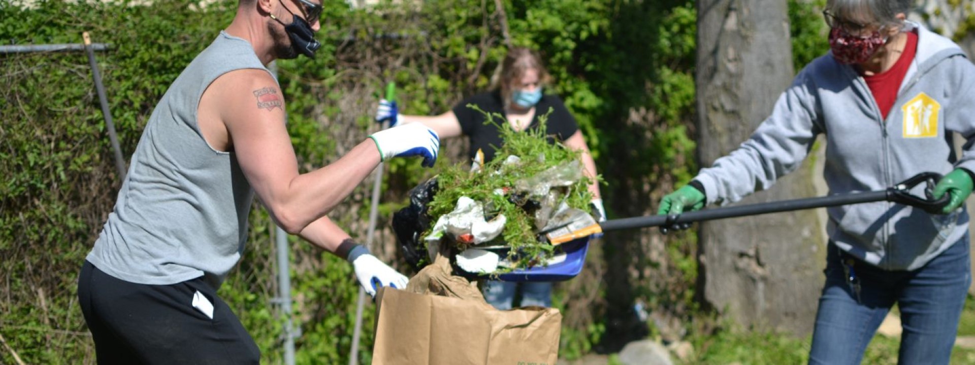 Project HOME volunteers picking up trash during a street clean-up.