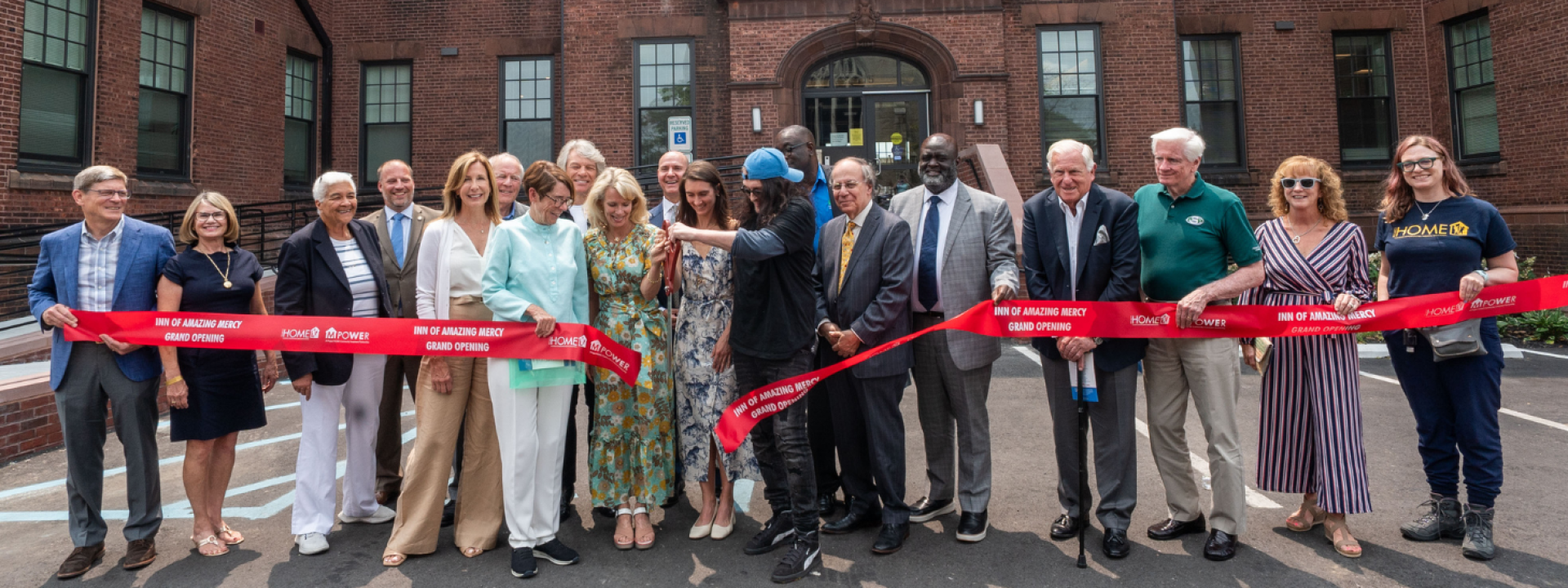 A group of people cutting a ribbon