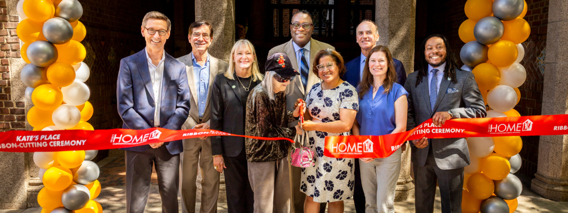 A group of people cutting a ribbon