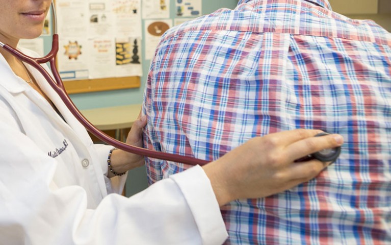 Doctor using a stethoscope on a patient
