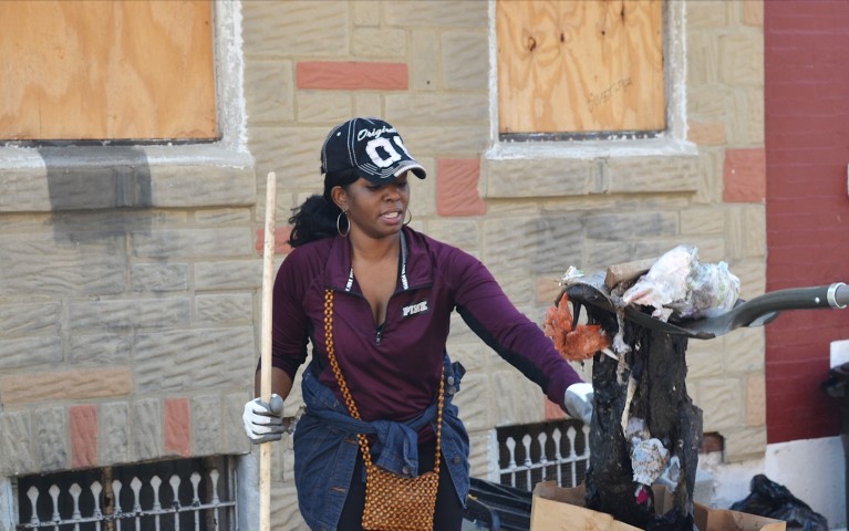 Person volunteering during a neighborhood clean up