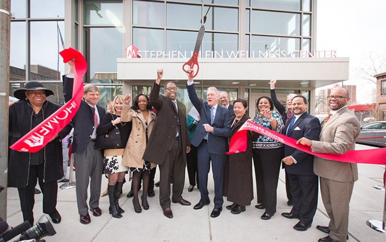 Guests cutting a ribbon at the grand opening for Stephen Klein Wellness Center
