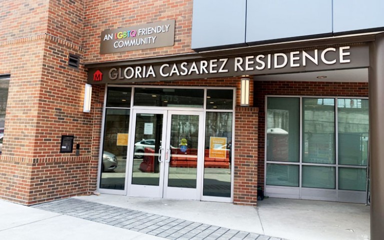 Gloria Casarez Residence's entrance with a sign that says "An LGBTQ Friendly Community."