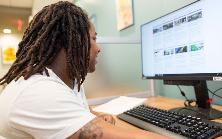 Young adult working at a desktop computer