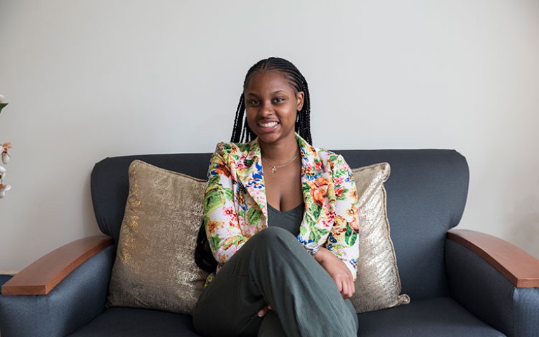 Former Project HOME Young Adult Resident sitting on a couch