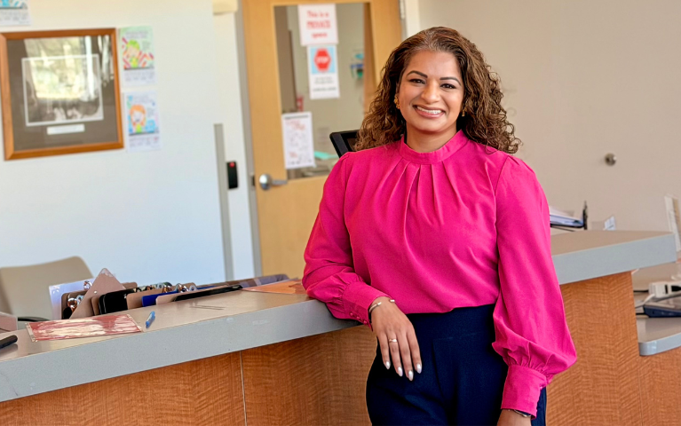 Smiling woman leaning against counter