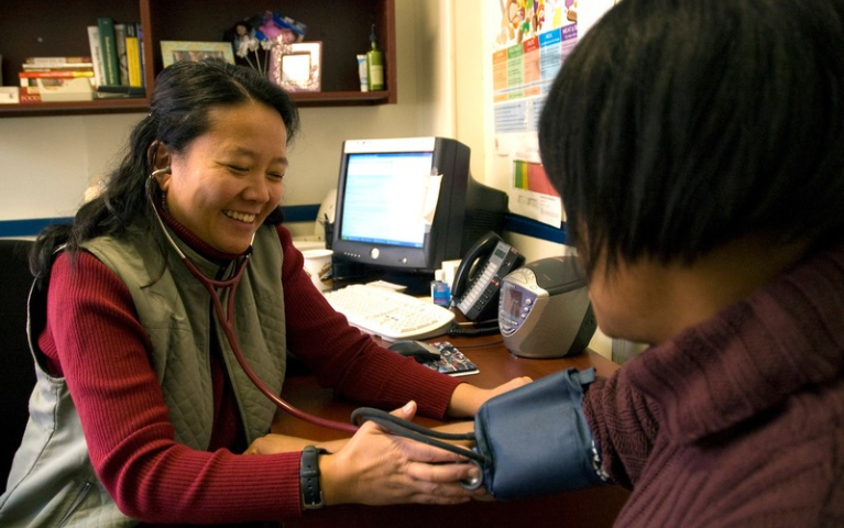 Monica Medina-McCurdy, former Project HOME physician assistant, takes a patient's blood pressure. 