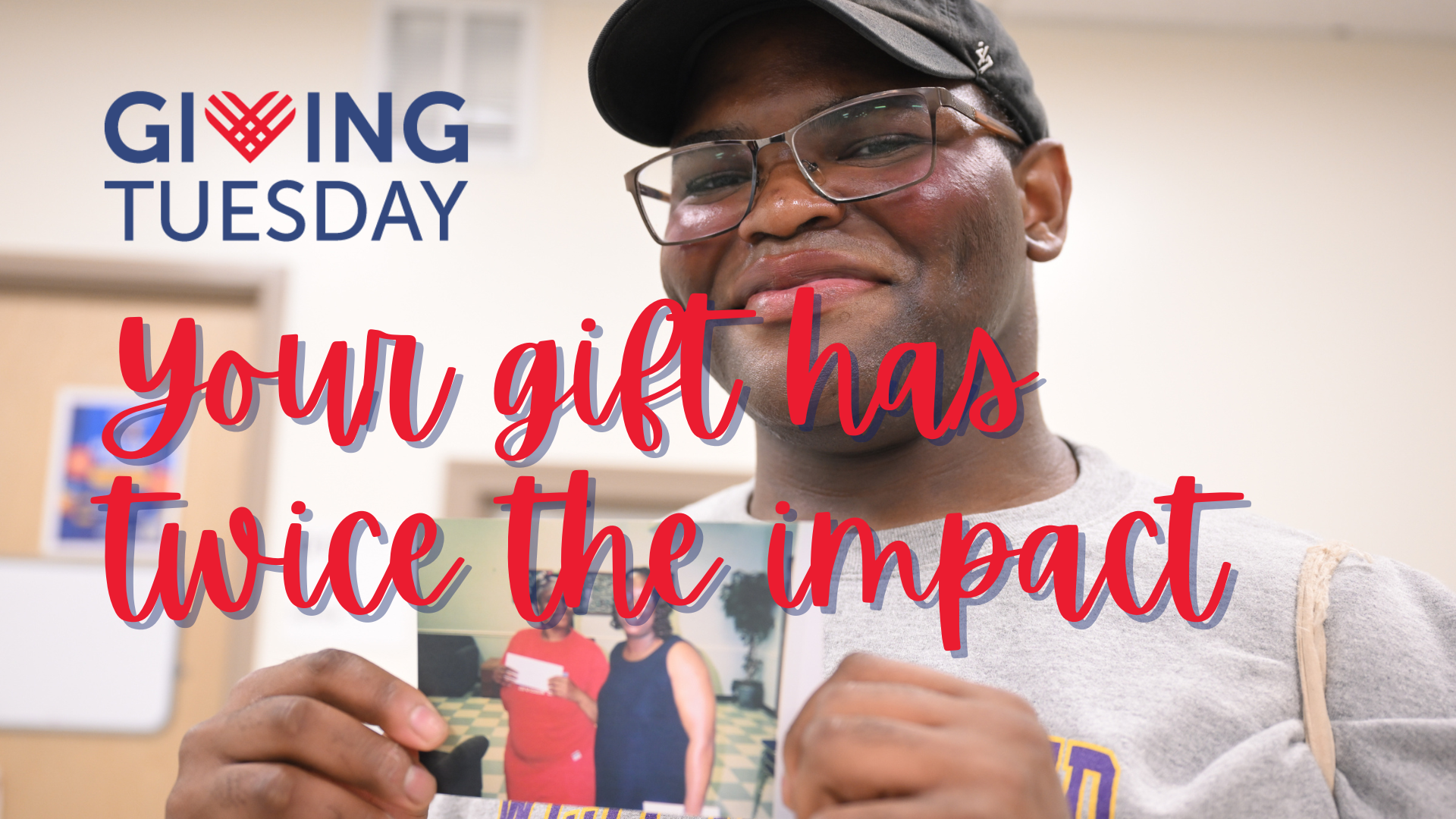 man holding picture and smiling