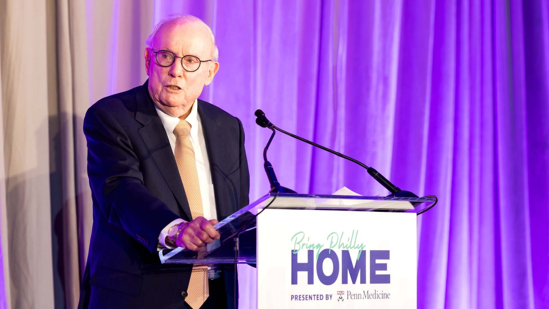 a man delivering remarks at a podium