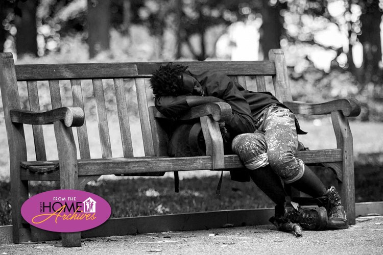 Man sleeping on park bench