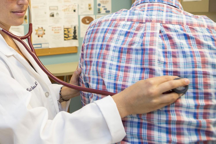 Doctor using a stethoscope on a patient