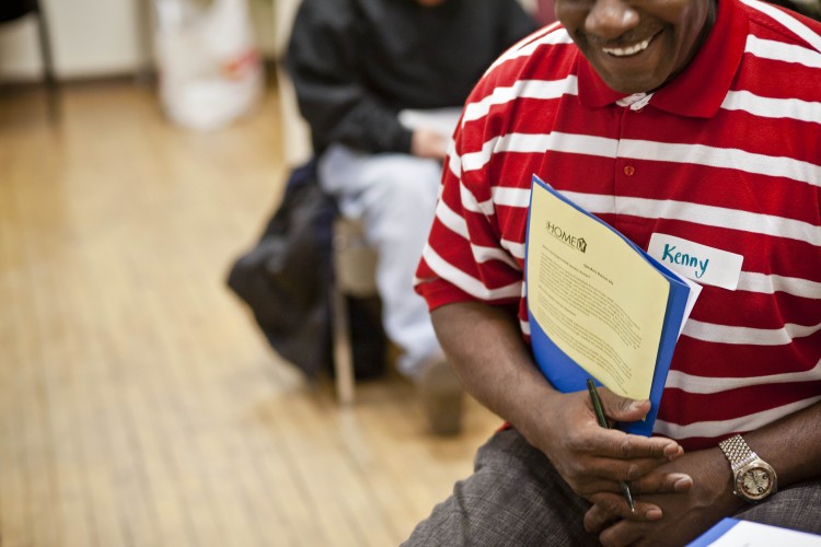 Person holding Speakers Bureau information while at a training