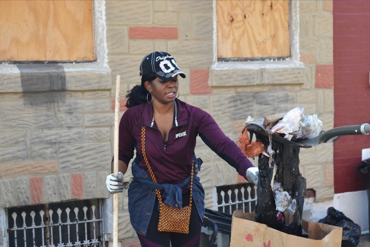 Person volunteering during a neighborhood clean up