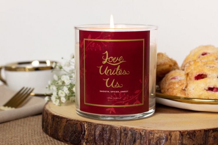 Image of Love Unites Us Candle lit on dinner table.