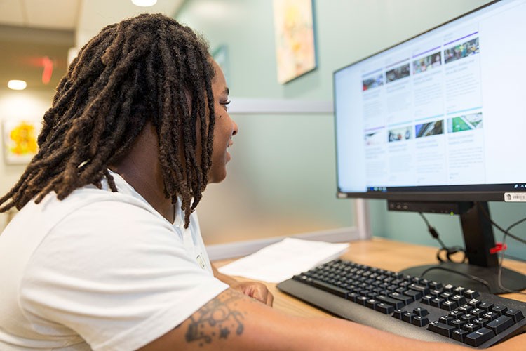 Young adult working at a desktop computer