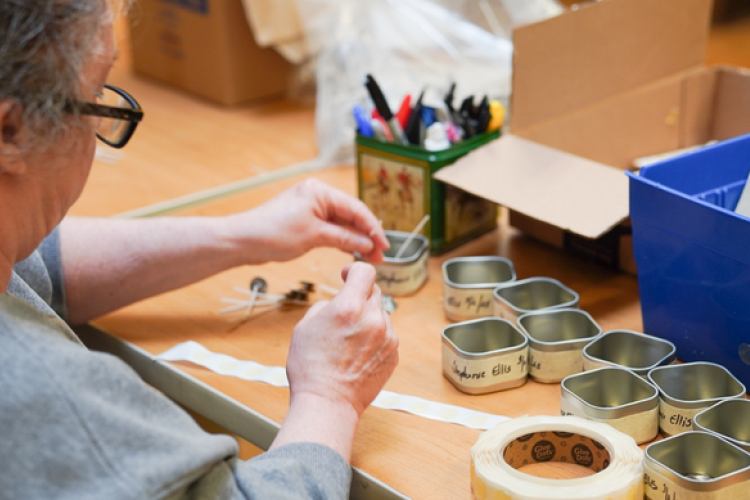 A resident securing wicks for the candles