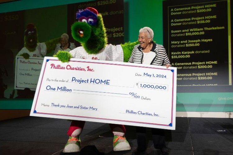 The Phillie Phanatic holds a ceremonial check for one million dollars