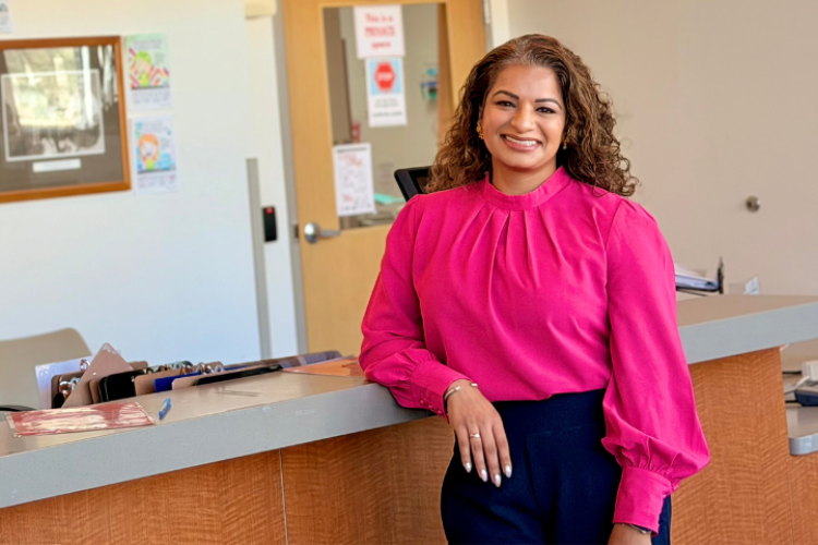 Smiling woman leaning against counter
