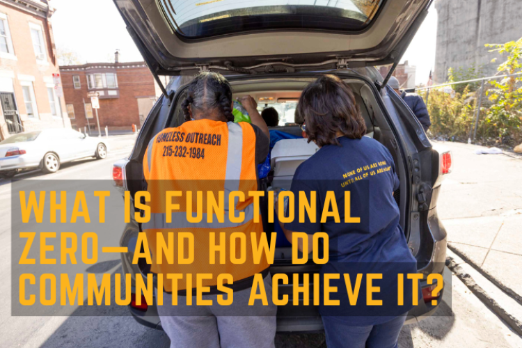 Two outreach workers getting water from the back of a van for people outside.