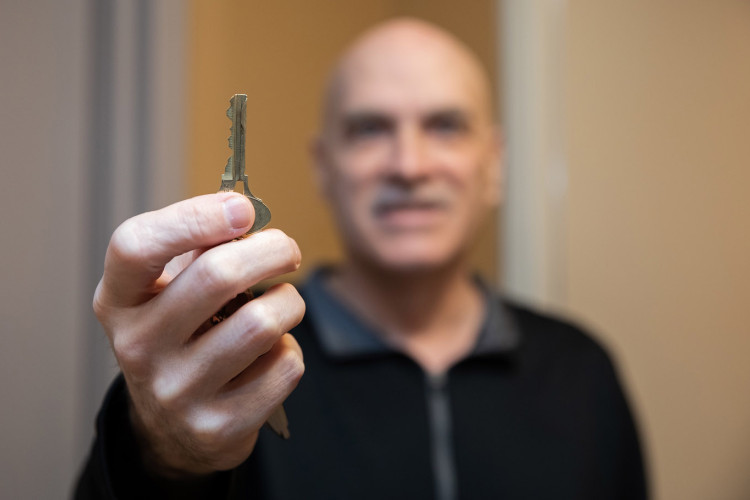 Man holding up a key