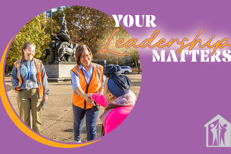 Project HOME CEO Donna Bullock and Senior Manager for Outreach Rachel Beilgard talk to a woman sitting in a park.