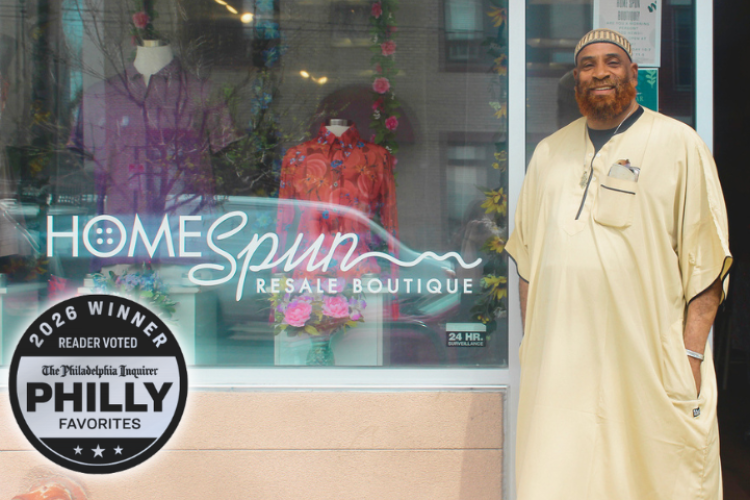 HOMEspun Boutique manager stands outside the store. Mannequins wearing colorful button-downs are visible through the window. A Silver badge in the lower left reads 2026 Winner, Reader Voted, The Philadelphia Inquirer, Philly Favorites.