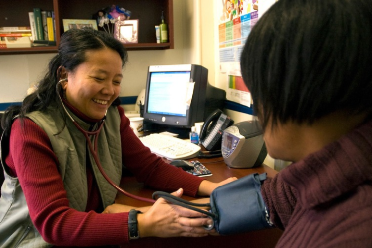 Monica Medina-McCurdy, former Project HOME physician assistant, takes a patient's blood pressure. 